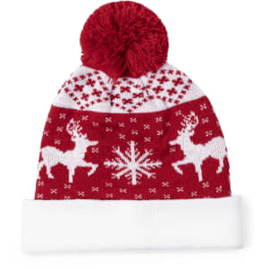 A red and white beanie with a pom-pom, featuring reindeer and snowflake patterns. It has a branded logo.