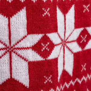 A red and white knitted scarf featuring a snowflake pattern. The design has a festive, cosy appearance.