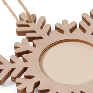 A wooden snowflake-shaped photo frame with a natural finish and a jute hanging cord.