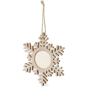 A wooden snowflake decoration in pale wood with cut-out snowflake patterns and a circular photo frame in the centre.