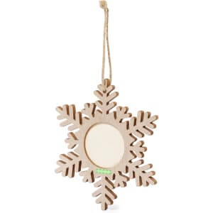 A wooden snowflake-shaped decoration featuring an empty circular frame for photos. It is light brown in colour and hung by a jute string.