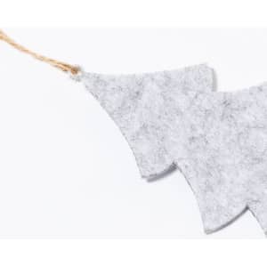 A grey felt Christmas decoration with a jagged design, hanging from a natural twine string.
