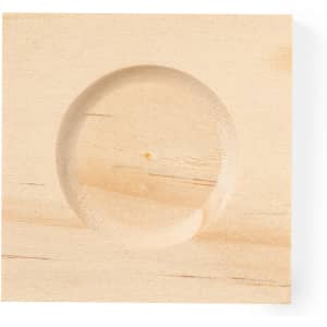 A wooden sand timer base with a circular indentation in a light wood finish.