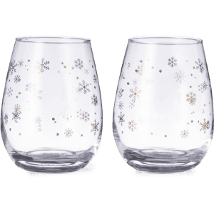 A set of clear glass cups with silver and gold snowflake designs. The glasses have a rounded shape.