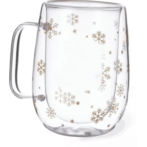 A transparent glass mug featuring gold snowflake designs and a curved handle. The design adds a festive touch.