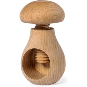 A wooden nutcracker shaped like a mushroom, featuring a smooth finish and a natural light wood colour.