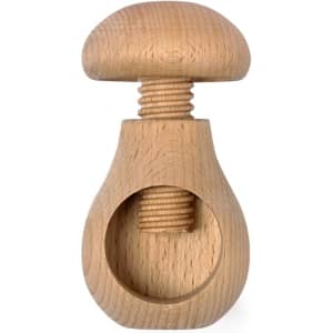 A wooden nutcracker with a smooth, rounded top and a spiral mechanism, showcasing a light wood finish.