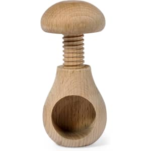 A wooden nutcracker with a mushroom-shaped top, featuring a smooth finish and natural wood grain.