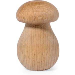 A wooden nutcracker in the shape of a mushroom, featuring a smooth, natural finish. It has a logo on the base.