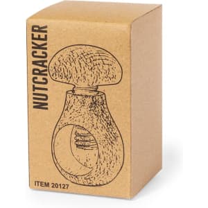 A wooden nutcracker inside a cardboard box with a simple, illustrated design in brown and beige tones.