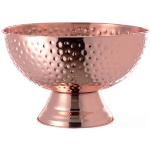 A copper ice bucket with a hammered finish and a pedestal base, featuring a shiny, reflective surface.