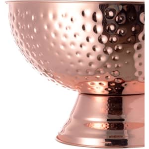 A copper-toned ice bucket with a hammered texture, featuring a wide bowl and a sturdy base.