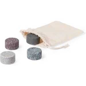 Four stone ice cubes in various colours: grey, dark green, light grey, and burgundy, placed near a fabric storage pouch.