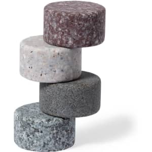 A stack of four round stone ice cubes in grey, white, maroon, and green hues, featuring a smooth texture.