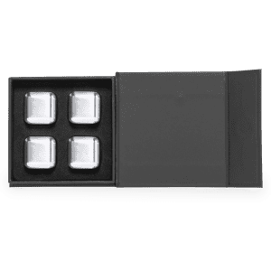 A set of four silver stone ice cubes in a black, open box. The box includes a logo.