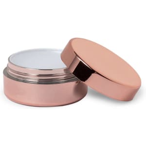 A rose gold lip balm container with a removable lid, featuring a smooth, empty interior.
