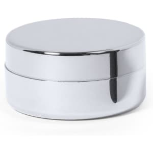 A metallic silver lip balm container with a smooth, round lid and base, featuring a simple design.