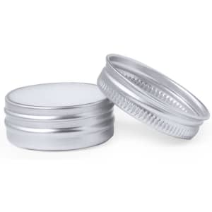 A silver metal tin with a ribbed edge, featuring a smooth, flat top and bottom.