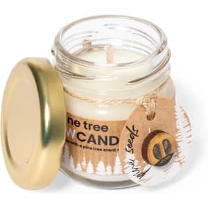A candle in a clear jar with a gold lid, featuring a pine tree scent and a rustic label.