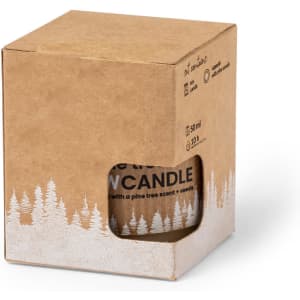 A cardboard box containing a candle with a pine tree scent. The box features a cut-out view and a logo.
