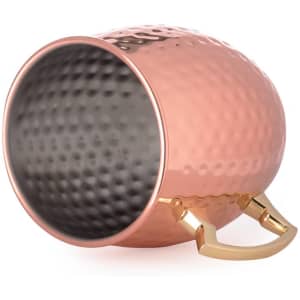 A copper-coloured mug with a textured exterior and a gold handle, featuring a smooth black interior.