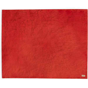 A red Durmok blanket with a soft texture, featuring a small logo in one corner.