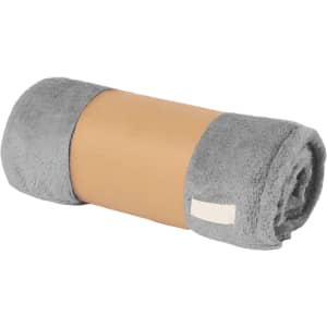 A rolled-up grey blanket secured with a cardboard band, featuring a small brand label.