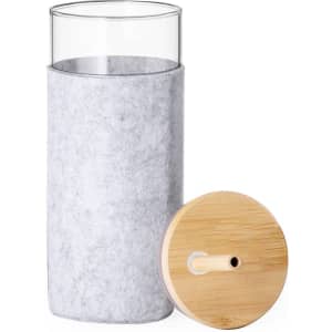 A grey felt cup holder with a clear inner glass and a bamboo lid featuring a drinking straw.