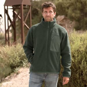 A polar fleece jacket in a deep green colour, featuring a zip and a chest pocket, worn by a man outdoors.