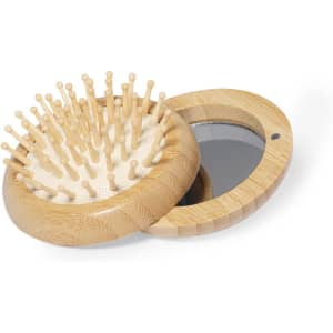 A bamboo hairbrush with wooden bristles and a mirror, featuring a circular, compact design.