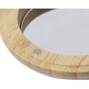 A bamboo hairbrush with a circular mirror, featuring a silver attachment. The natural wood finish highlights its design.