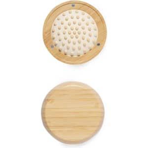 A bamboo hairbrush featuring a circular design with a mirror, showcasing a light timber finish and rounded bristles.