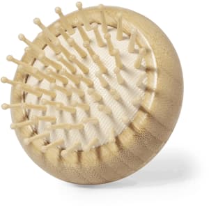 A gold-toned hairbrush with a mirror and rounded bristles, featuring a textured surface and a branding logo.