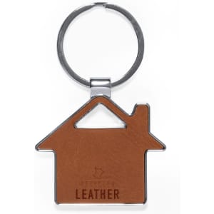 A brown leather keyring shaped like a house, featuring a silver ring and a logo.