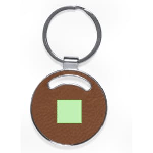 A round keyring with a silver metal loop and a brown textured circular body featuring a small green square.