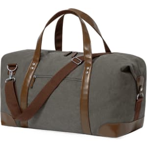 A grey duffel bag with brown leather accents and straps, featuring a side pocket and adjustable shoulder strap.