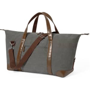 A grey bag with brown leather accents and handles, featuring a shoulder strap and a front pocket, and includes a logo.