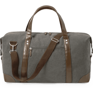 A grey duffel bag with brown leather accents and a detachable shoulder strap. It features a zippered pocket.
