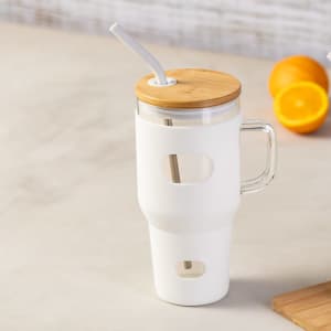 A drink bottle with a white body, bamboo lid, and a straw, featuring a handle and cut-out design.