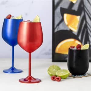 A drinkware set featuring a blue and a red wine glass alongside a black cup, all with refreshing garnishes.