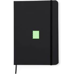 A black notepad with a small green square design and an elastic closure. It has a ribbon bookmark.