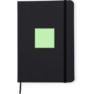 A black notepad with a green square design on the front and an elastic band closure. It has a logo.