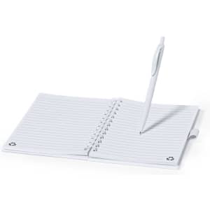 A white spiral notebook with lined pages and a matching pen placed on top. It features a logo on the corner.