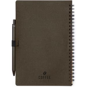 A dark brown spiral-bound notebook with a pen attached, featuring a logo on the front cover.