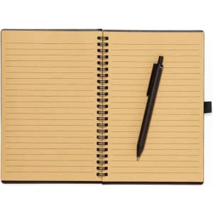 A spiral-bound notebook with lined pages in a tan colour, accompanied by a black pen. It features a logo on the cover.