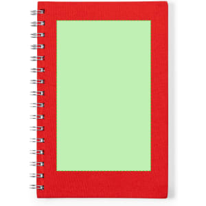 A red notepad with a green blank section on the front cover and a spiral binding.