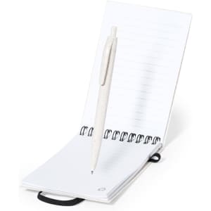 A white spiral notebook with blank pages and a matching white pen resting on it. The notebook has a black strap.