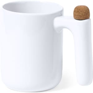 A white coffee mug featuring a unique handle with a cork accent. The design is sleek and minimalist.