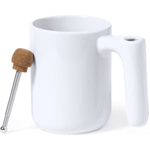 A white coffee mug with a cork handle and a silver spoon attached. Features a simple, modern design.