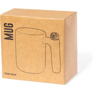 A coffee mug in a plain brown box with a simple outline illustration on the side. The mug has a handle and is unbranded.